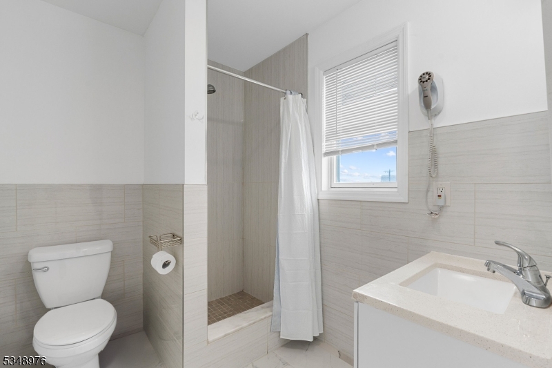 129 Franklin Avenue, Unit B Seaside Heights, NJ 08751 - Photo 10 of 22 a bathroom with a toilet sink and shower