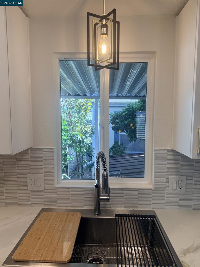 60 Wilson Way Milpitas, CA 95035 - Photo 6 of 22 a bathroom with a sink a mirror and window