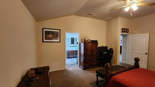 a bedroom with a workspace