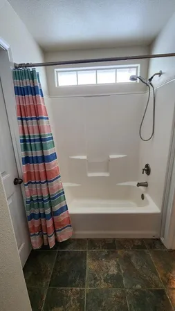 a bathroom with a bathtub and a shower