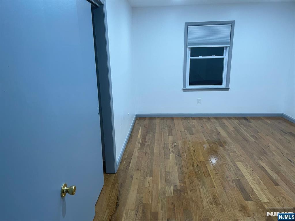 607 Nassau Street, Unit 2 Orange, NJ 07050 - Photo 6 of 10 a view of a hallway with wooden floor and a window
