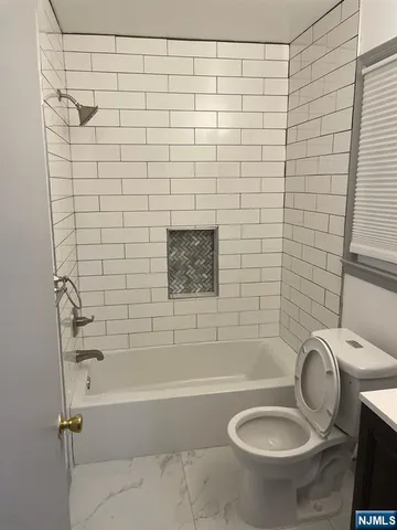a bathroom with a shower and a toilet