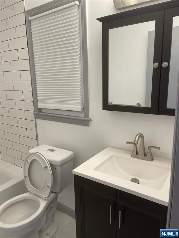 607 Nassau Street, Unit 2 Orange, NJ 07050 - Photo 10 of 10 a bathroom with a toilet sink and mirror