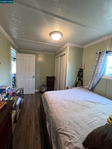 a bedroom with a bed and a large mirror