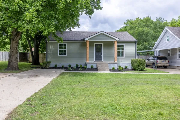 a front view of house with yard and green space