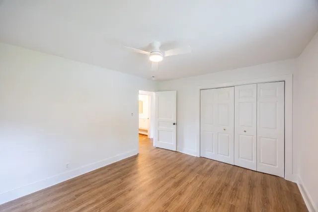 a view of an empty room and wooden floor