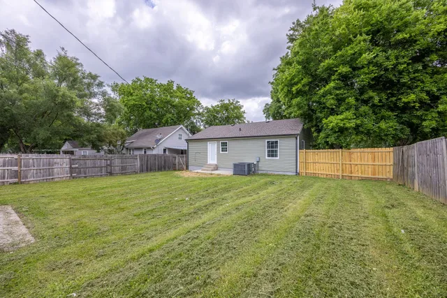 a house with green field in front of it