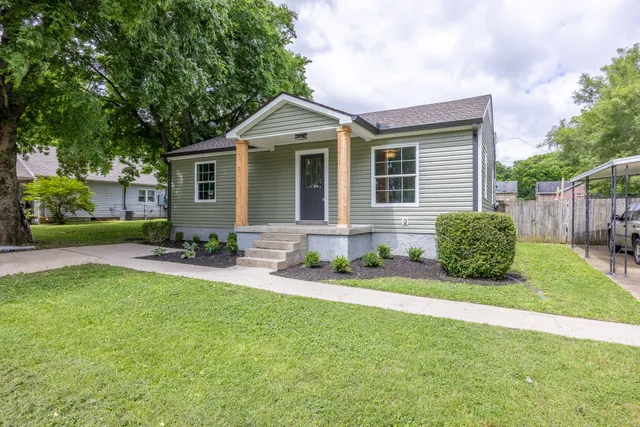 a front view of house with yard and green space