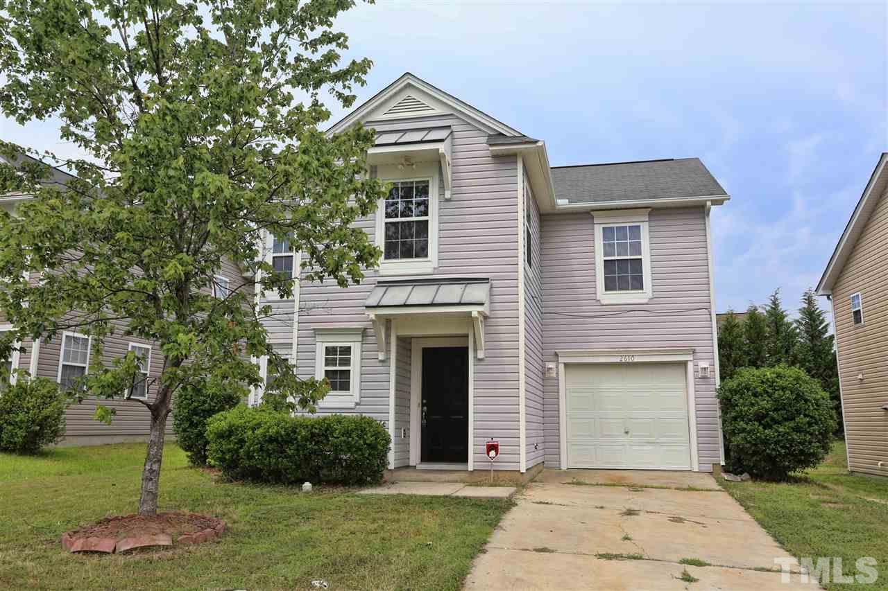 2610 Quarry Ridge Lane Raleigh, NC 27610 - Photo 1 of 23 a front view of a house with a yard and garage