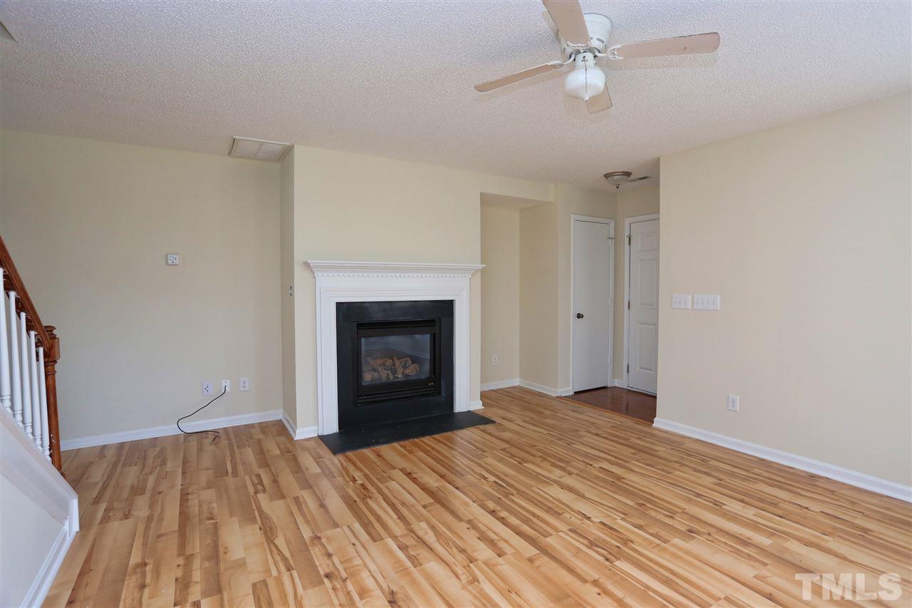 2610 Quarry Ridge Lane Raleigh, NC 27610 - Photo 3 of 23 wooden floor fireplace and natural light in room