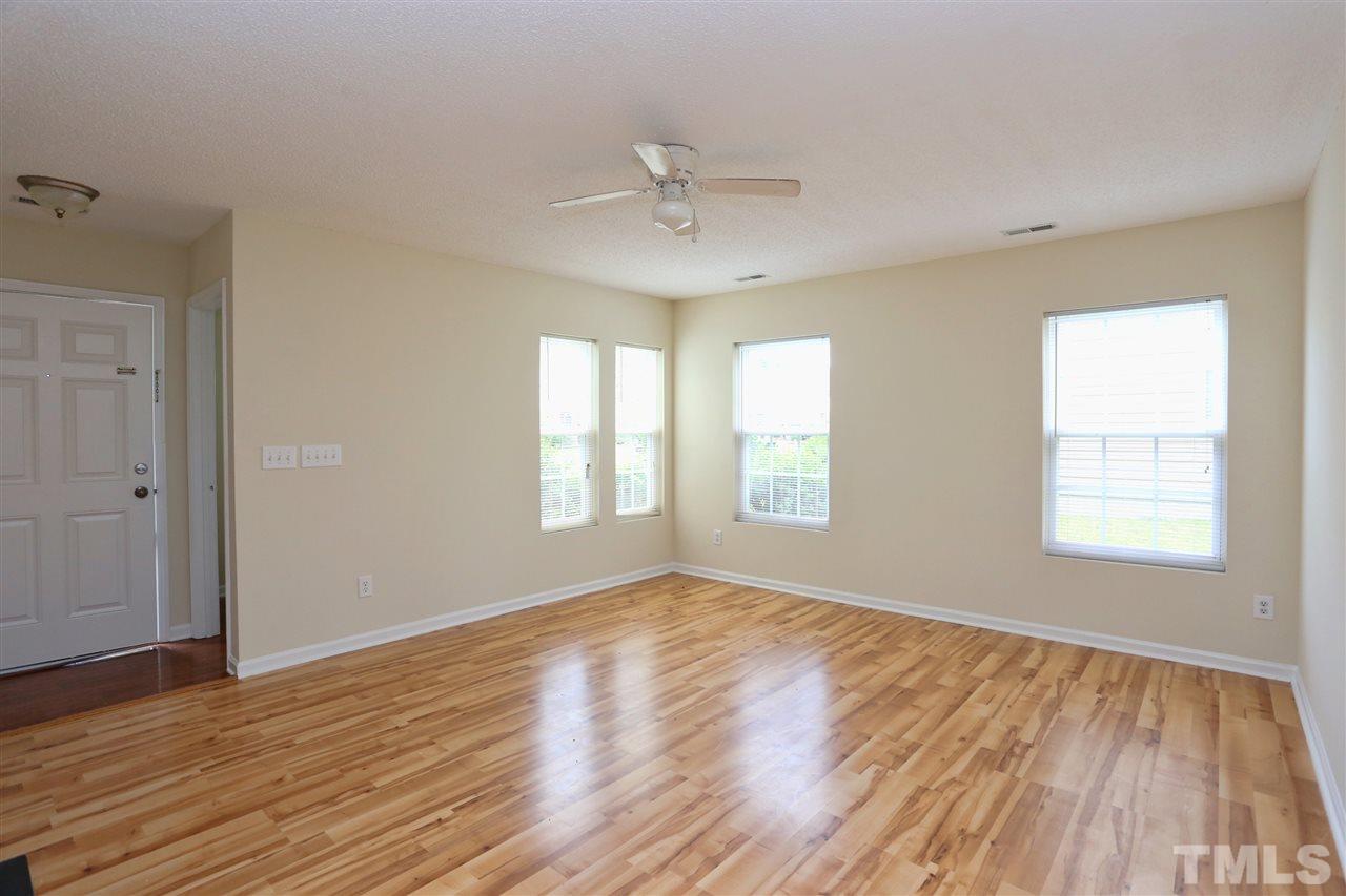 2610 Quarry Ridge Lane Raleigh, NC 27610 - Photo 4 of 23 a view of an empty room with wooden floor and a window