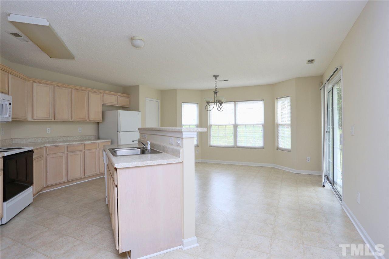 2610 Quarry Ridge Lane Raleigh, NC 27610 - Photo 7 of 23 a kitchen with kitchen island a sink stove and cabinets