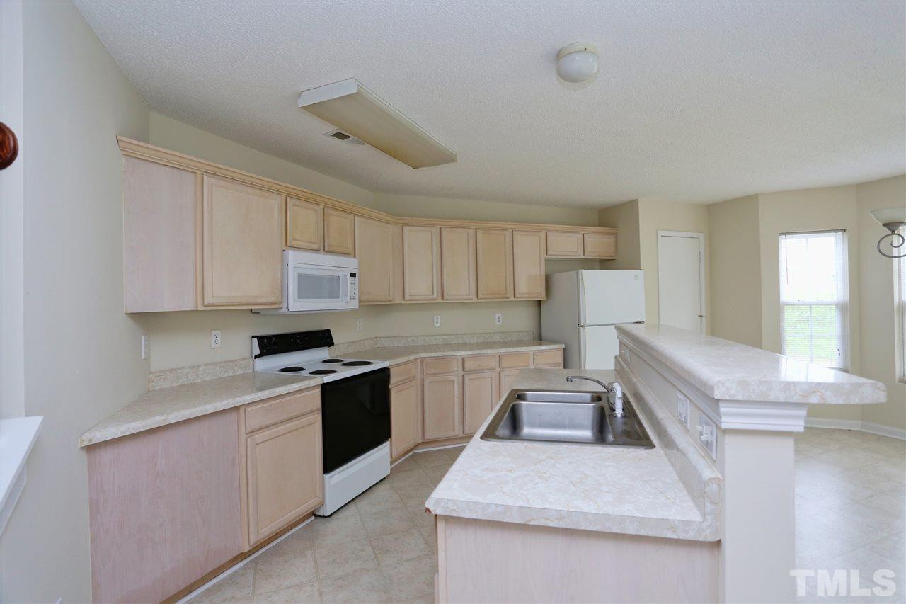2610 Quarry Ridge Lane Raleigh, NC 27610 - Photo 8 of 23 a kitchen with a sink stove and cabinets