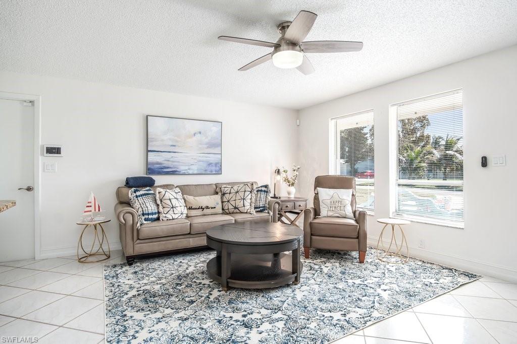 1207 Hernando Street Naples, FL 34103 - Photo 1 of 37 a living room with furniture and a rug