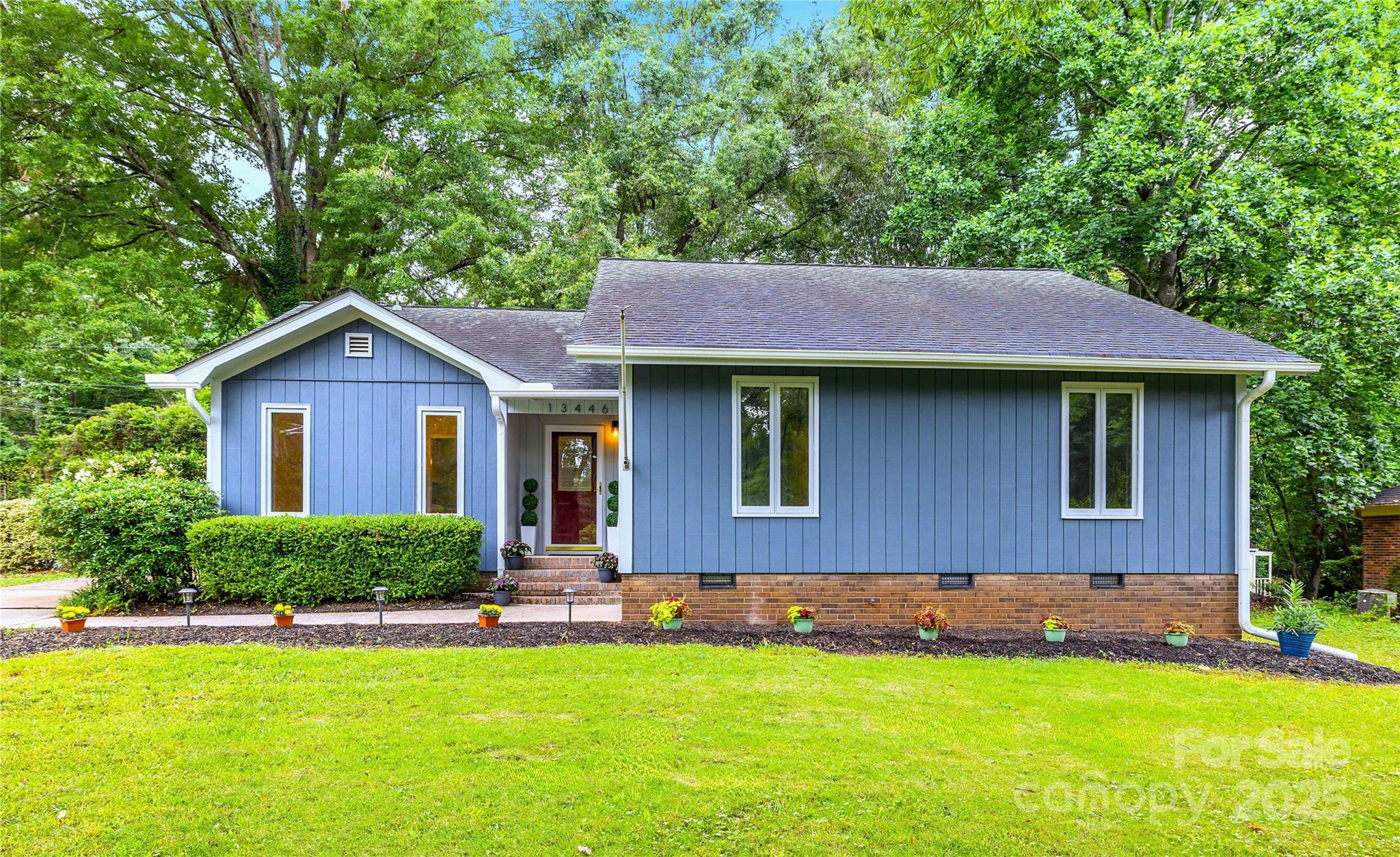 13446 Idlefield Lane Matthews, NC 28105 - Photo 1 of 42 a front view of a house with a yard and green space