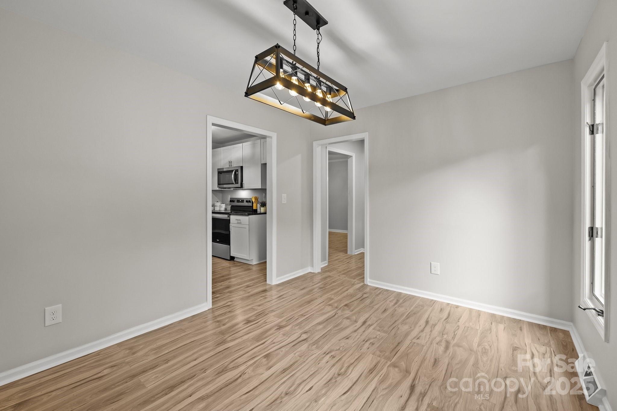 13446 Idlefield Lane Matthews, NC 28105 - Photo 11 of 42 a view of an empty room with window and wooden floor
