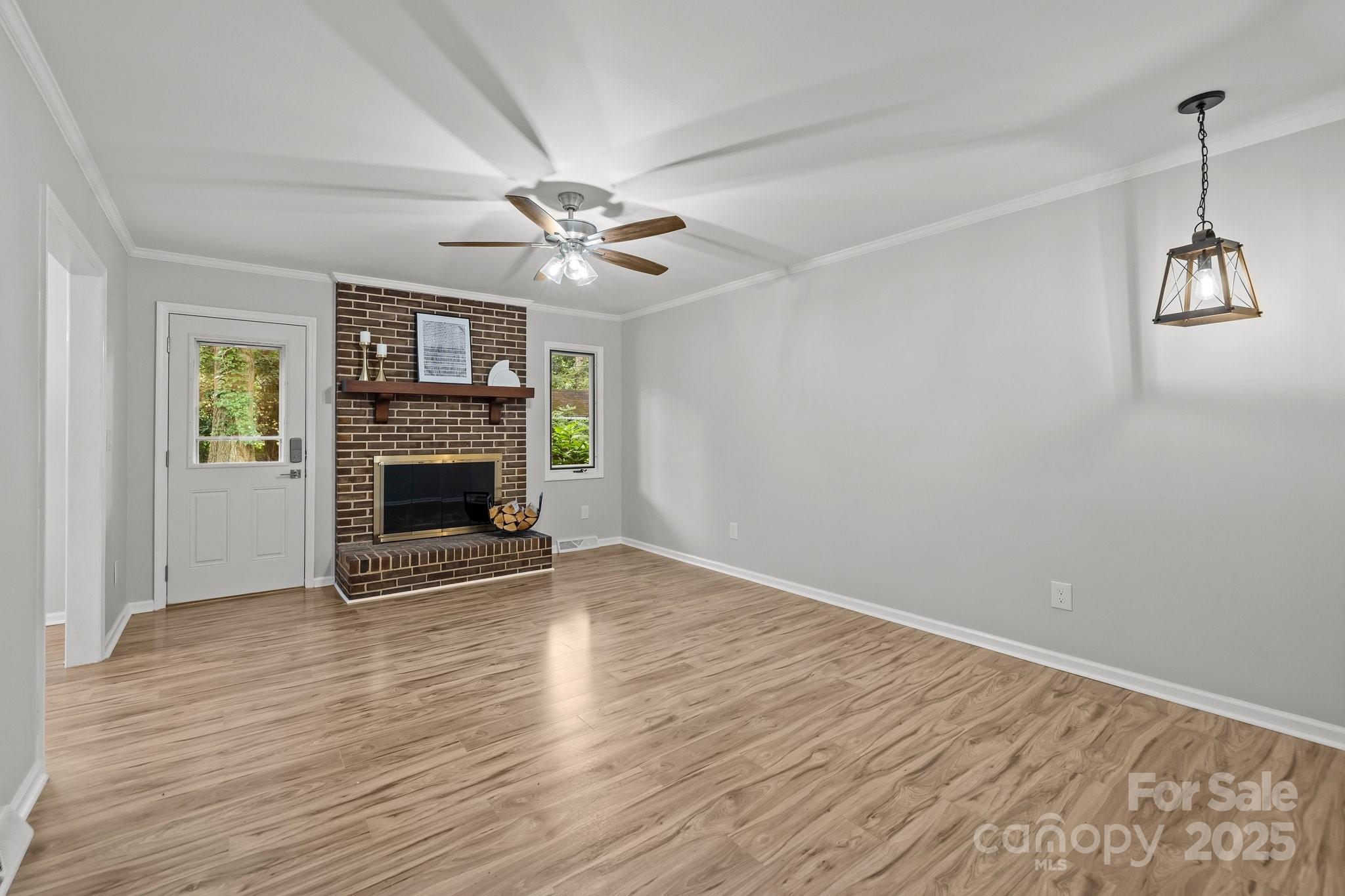 13446 Idlefield Lane Matthews, NC 28105 - Photo 15 of 42 an empty room with windows fireplace and a sink