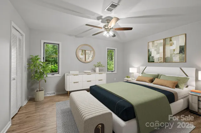 a bedroom with a bed and a chandelier