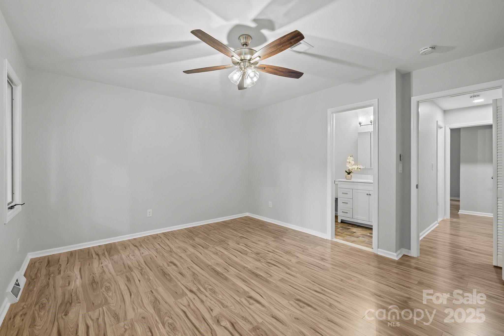13446 Idlefield Lane Matthews, NC 28105 - Photo 19 of 42 an empty room with wooden floor and ceiling fan