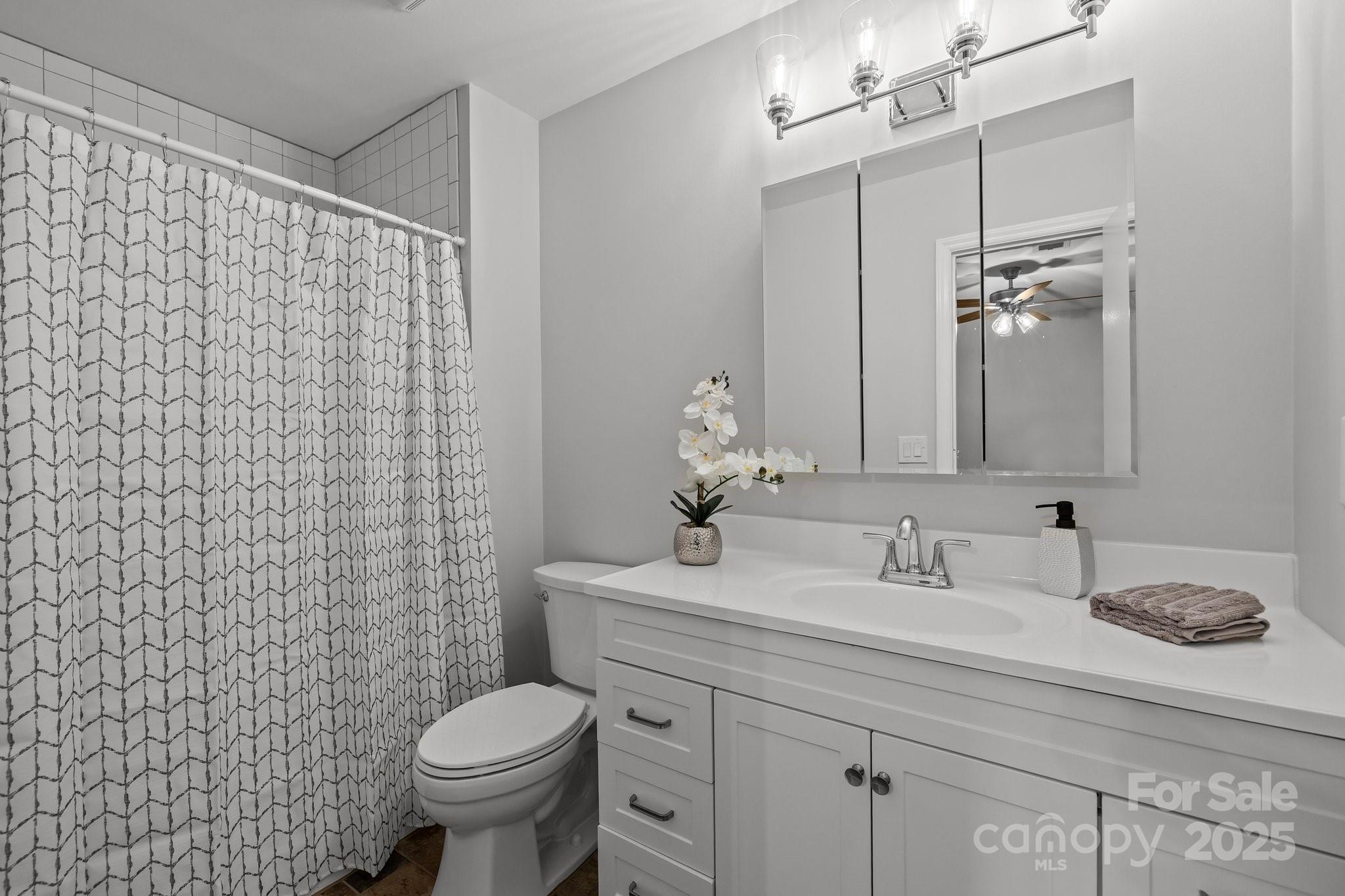 13446 Idlefield Lane Matthews, NC 28105 - Photo 21 of 42 a bathroom with a granite countertop sink a toilet and a mirror