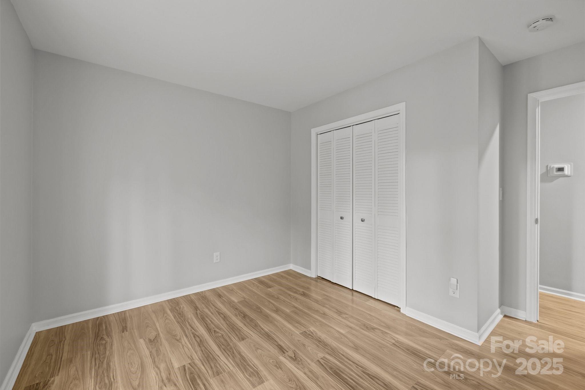 13446 Idlefield Lane Matthews, NC 28105 - Photo 23 of 42 a view of an empty room with wooden floor and entryway