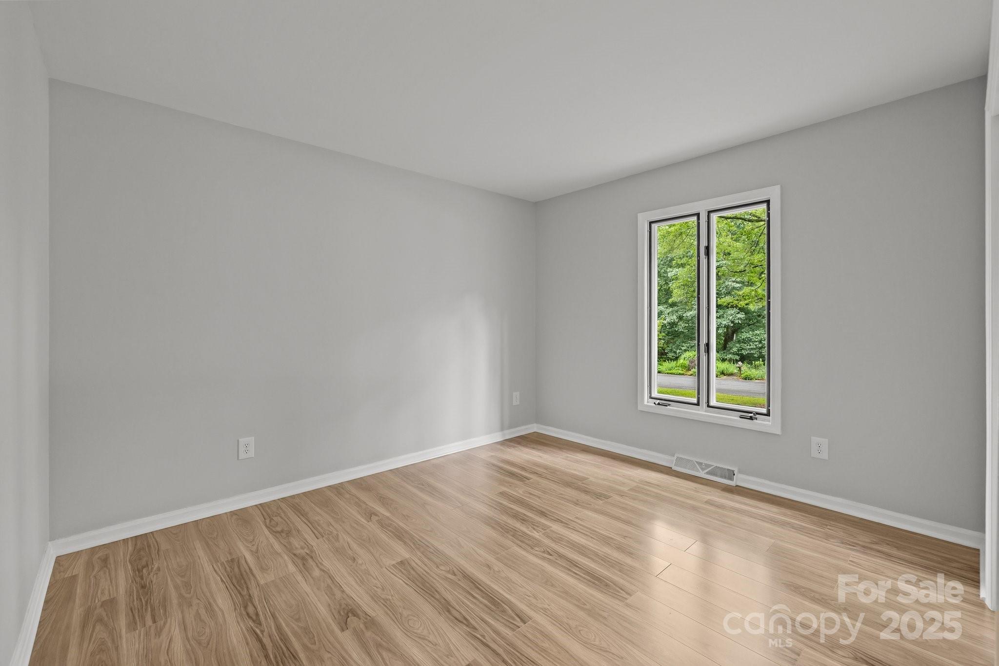 13446 Idlefield Lane Matthews, NC 28105 - Photo 25 of 42 a view of an empty room with wooden floor and a window