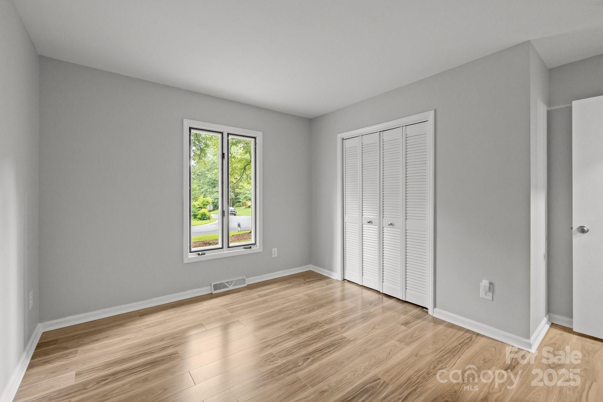 13446 Idlefield Lane Matthews, NC 28105 - Photo 26 of 42 a view of an empty room with wooden floor and a window