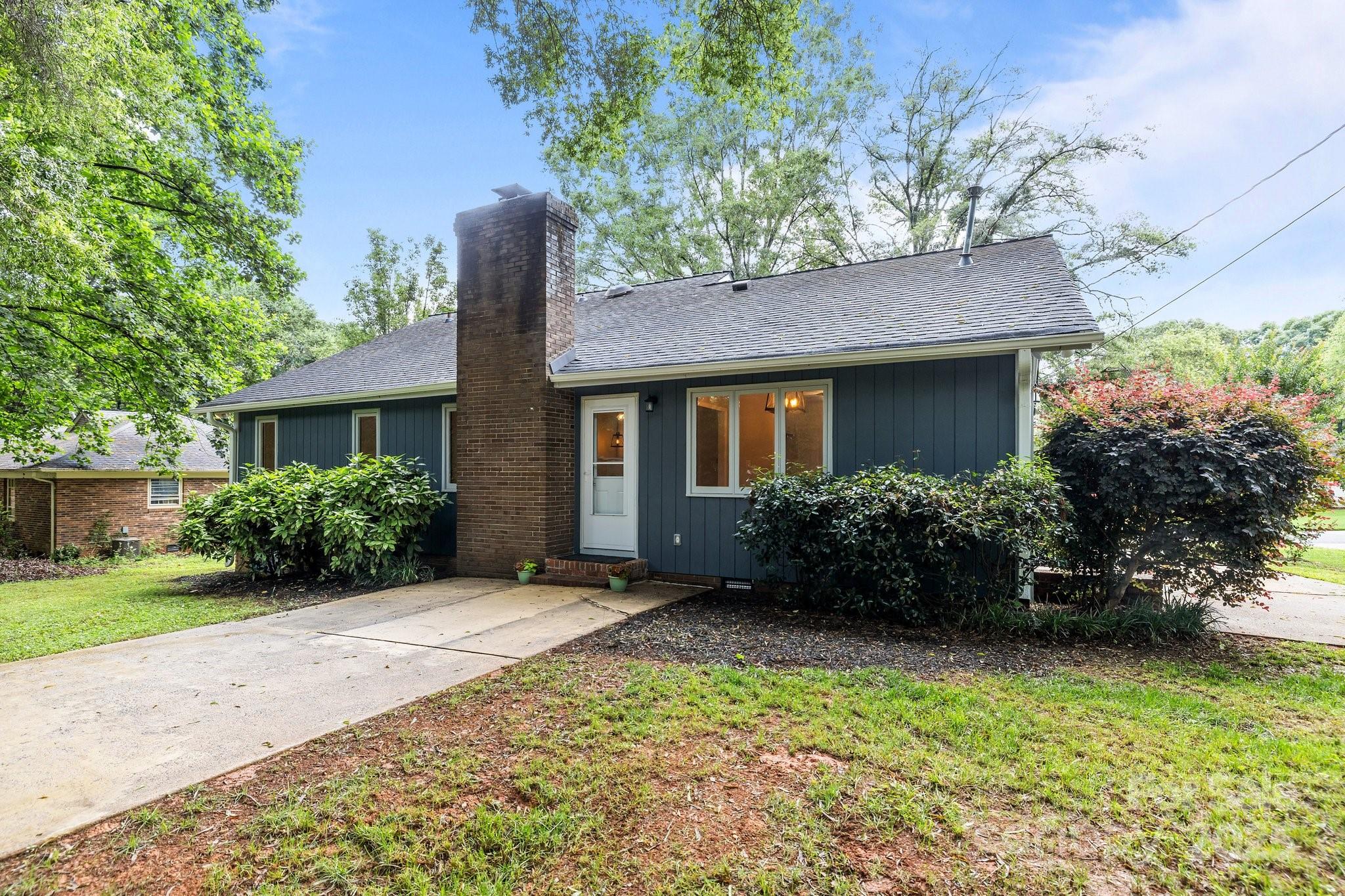 13446 Idlefield Lane Matthews, NC 28105 - Photo 31 of 42 a front view of a house with garden