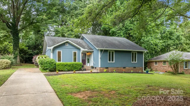 a front view of house with yard and green space