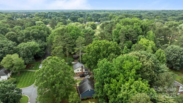 an aerial view of a houses with a yard