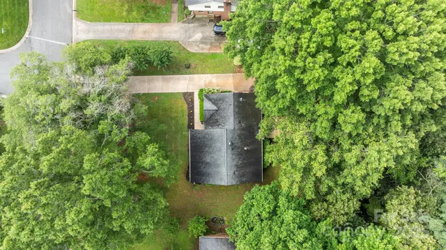 an aerial view of a house with a yard