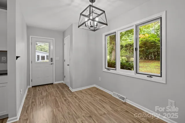 a view of a room with wooden floor cabinet and windows