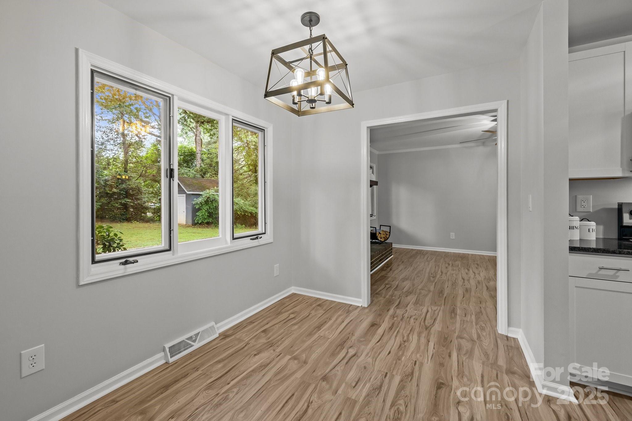 13446 Idlefield Lane Matthews, NC 28105 - Photo 8 of 42 a view of empty room with wooden floor and fan