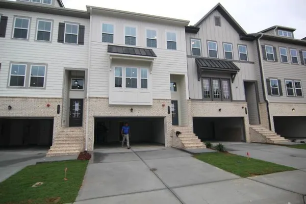 a front view of a house with a yard and a garage