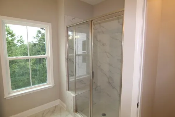 a bathroom with a glass shower door