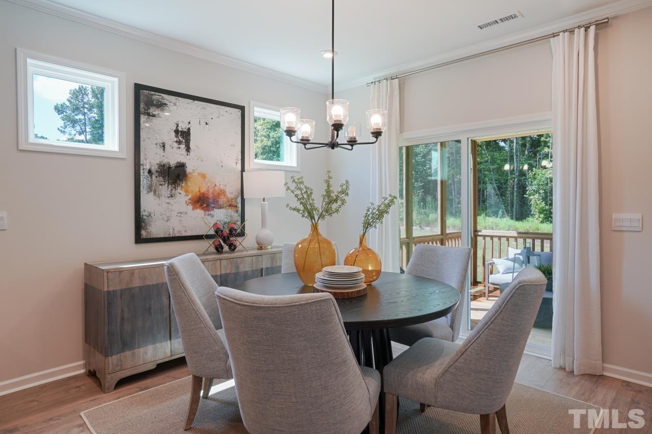 232 Brody Pine Way Garner, NC 27529 - Photo 12 of 35 a view of a dining room with furniture wooden floor and chandelier