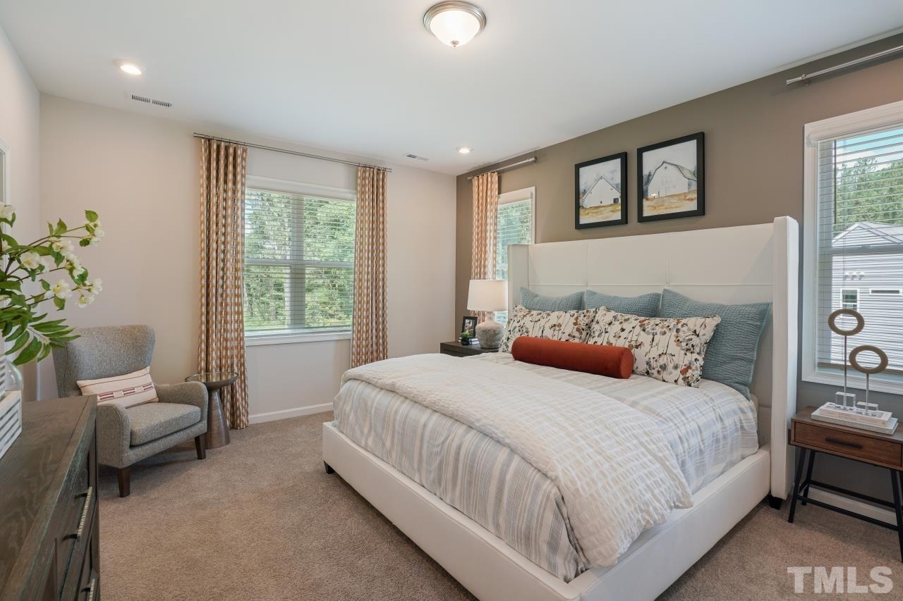 232 Brody Pine Way Garner, NC 27529 - Photo 18 of 35 a bedroom with a large bed and a window