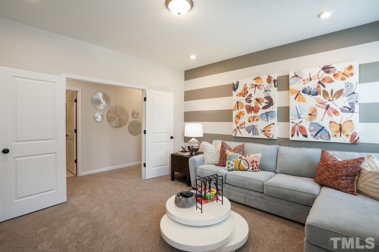 232 Brody Pine Way Garner, NC 27529 - Photo 24 of 35 a living room with furniture and a large window