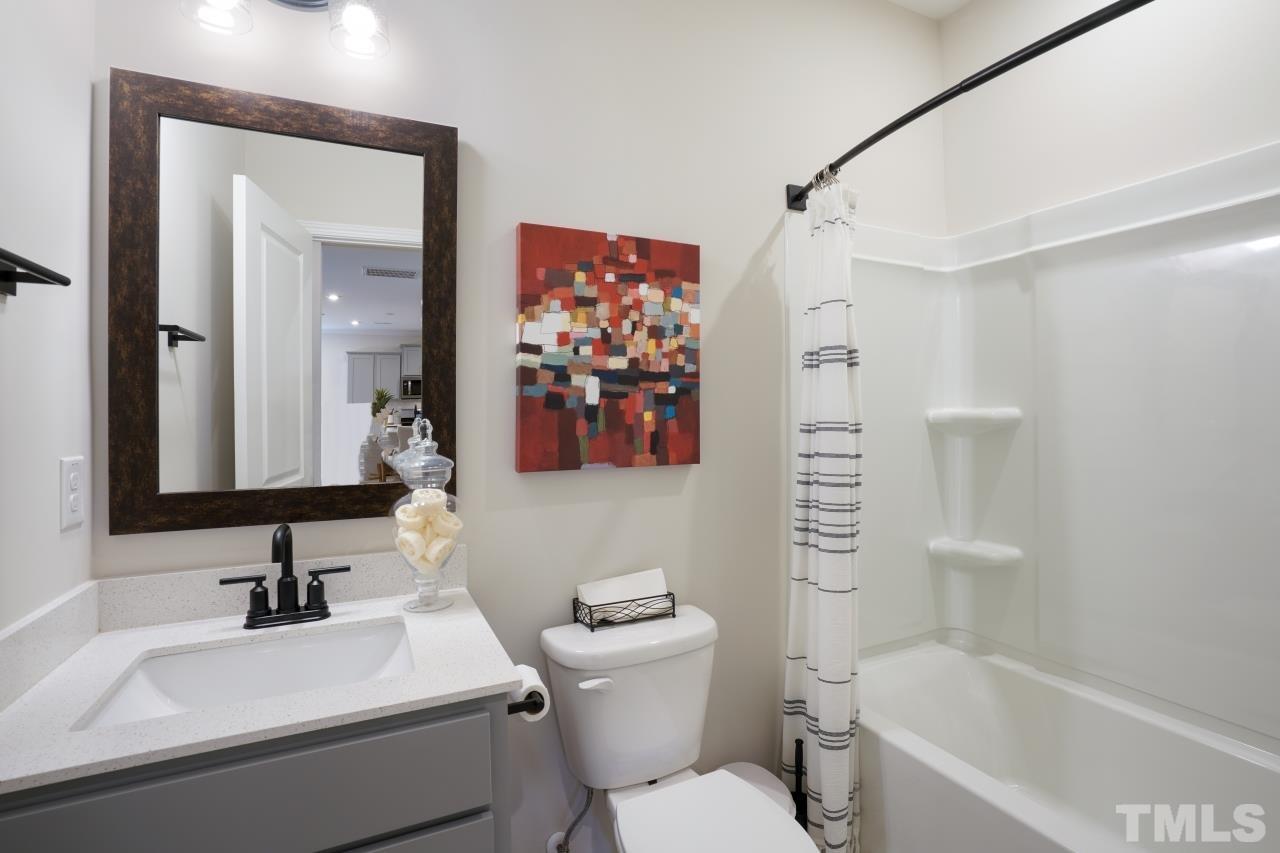 232 Brody Pine Way Garner, NC 27529 - Photo 31 of 35 a bathroom with a sink toilet and shower