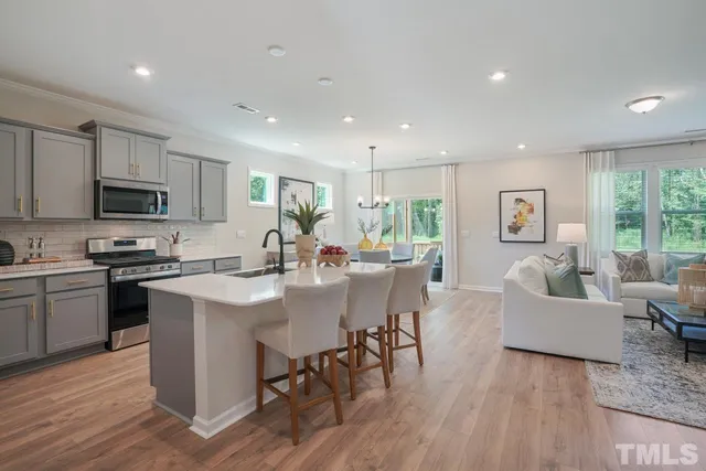 a living room with furniture and a painting on the wall