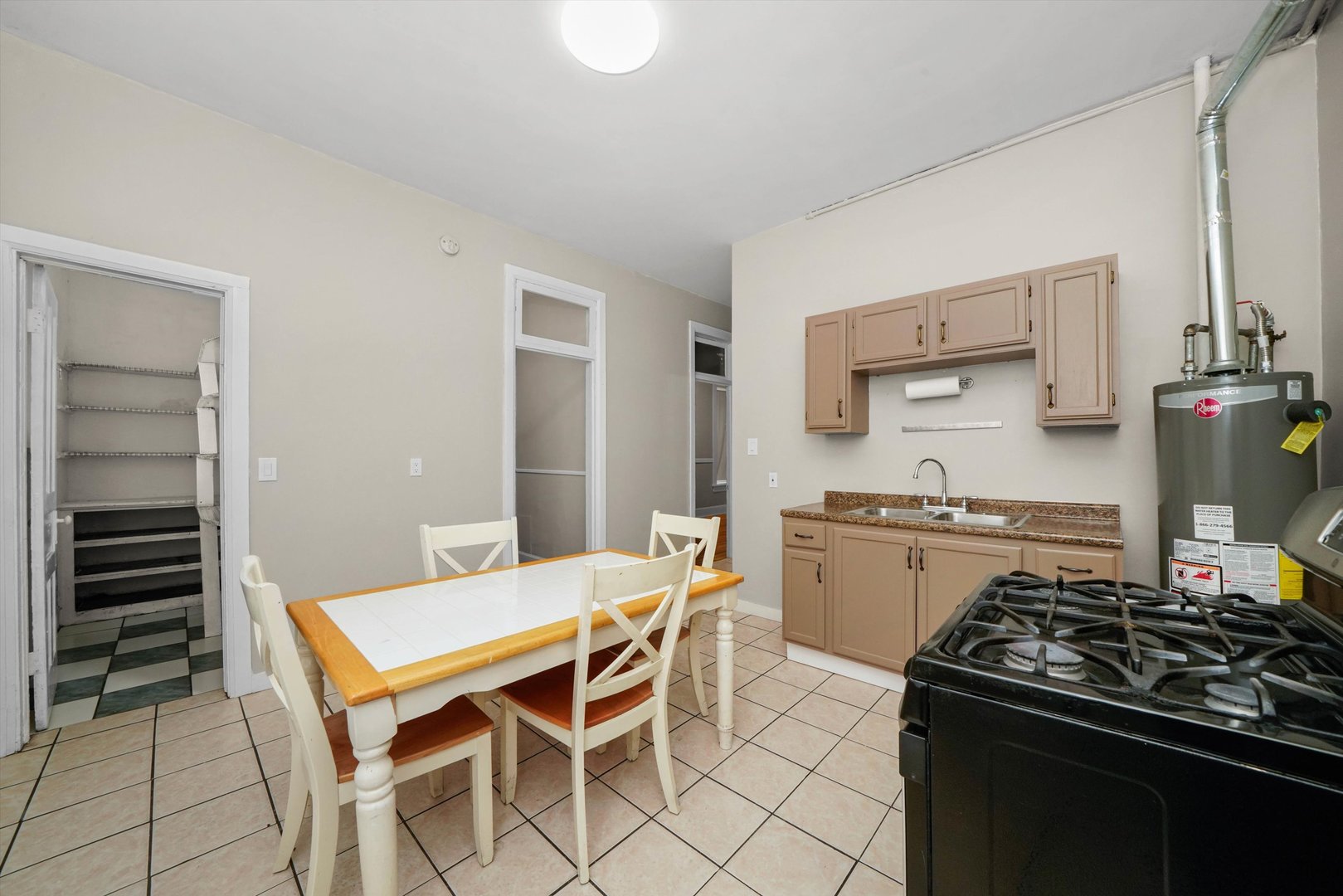2140 West Cermak Road Chicago, IL 60608 - Photo 18 of 43 a kitchen with a stove and white cabinets