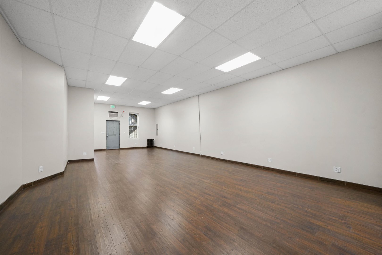 2140 West Cermak Road Chicago, IL 60608 - Photo 20 of 43 a view of a room with wooden floor and window