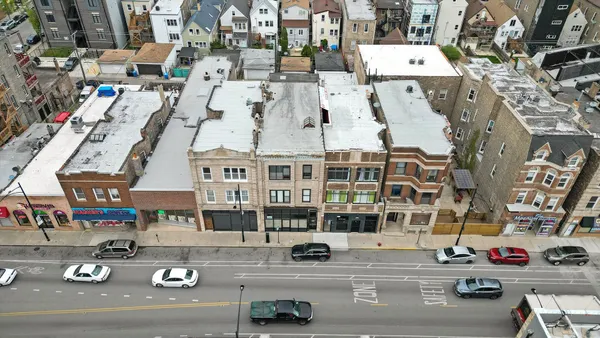 an aerial view of a residential houses with outdoor space