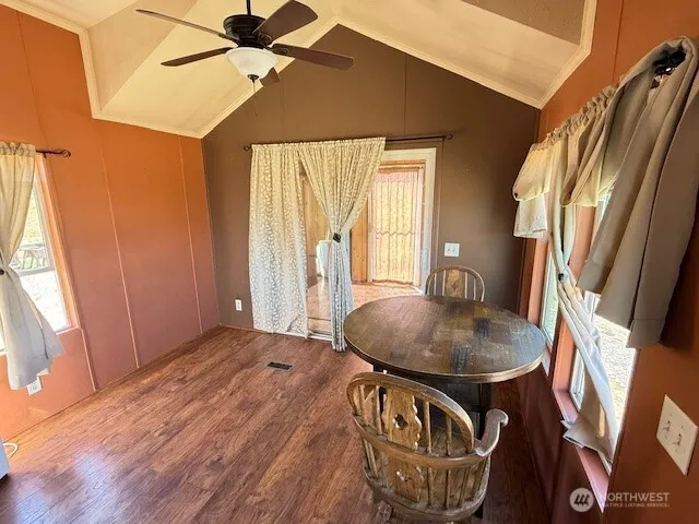 a backyard of a house with table and chairs