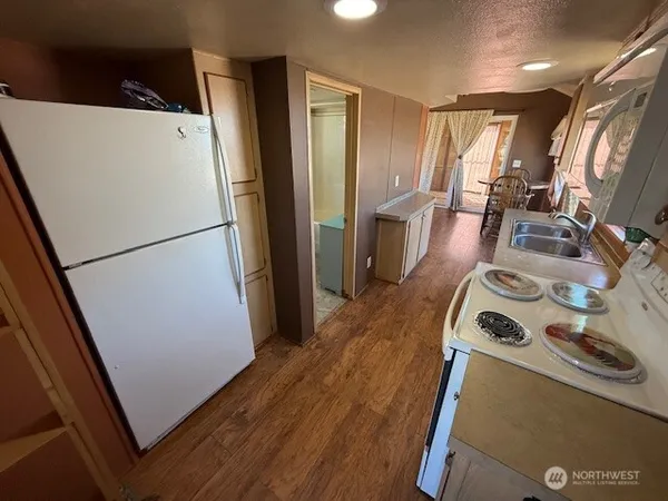 a view of a bedroom with wooden floor and windows