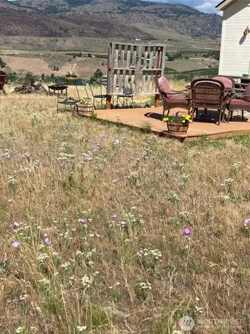 a view of a backyard with table and chairs