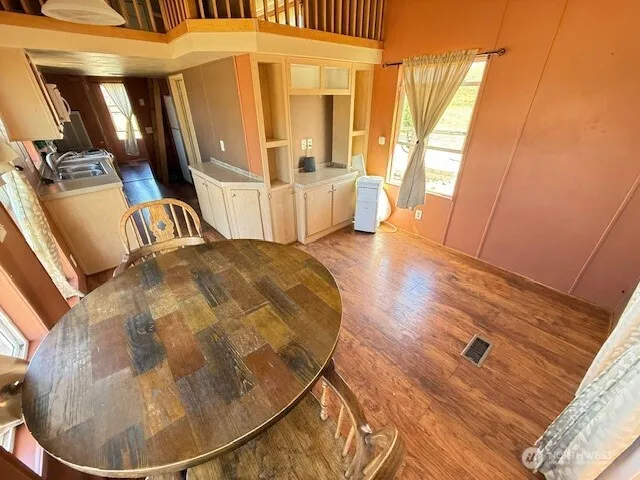 a view of a livingroom with furniture wooden floor and windows