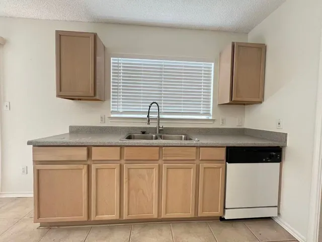 a kitchen with white cabinets and a sink
