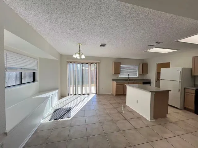 a kitchen with cabinets and refrigerator