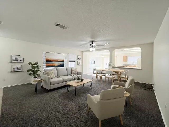 a living room with furniture and a chandelier